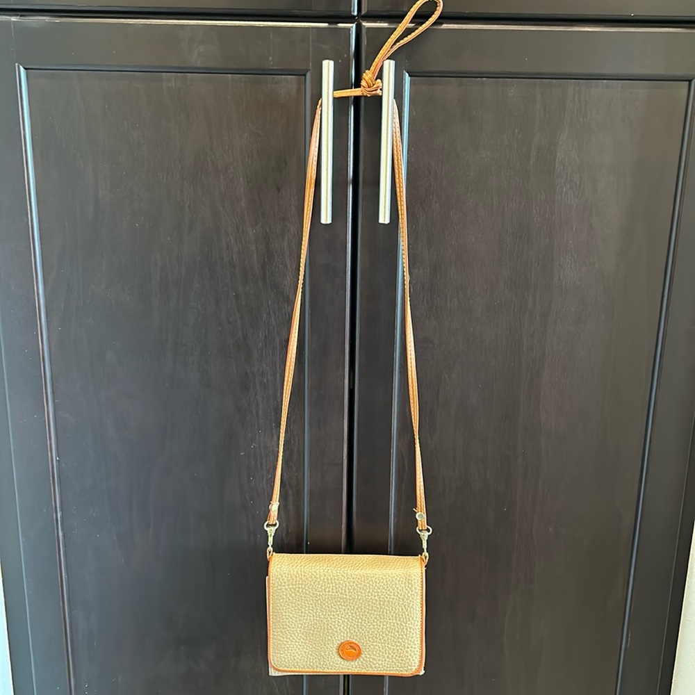 Dooney & Bourke tan crossbody bag.  A lot of space for credit cards & more.